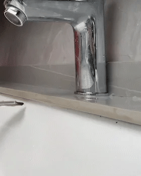 Crevice brush cleaning tile grout — before and after